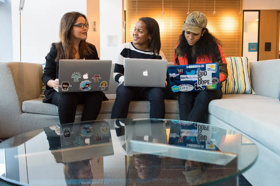 Three developers working together on laptops
